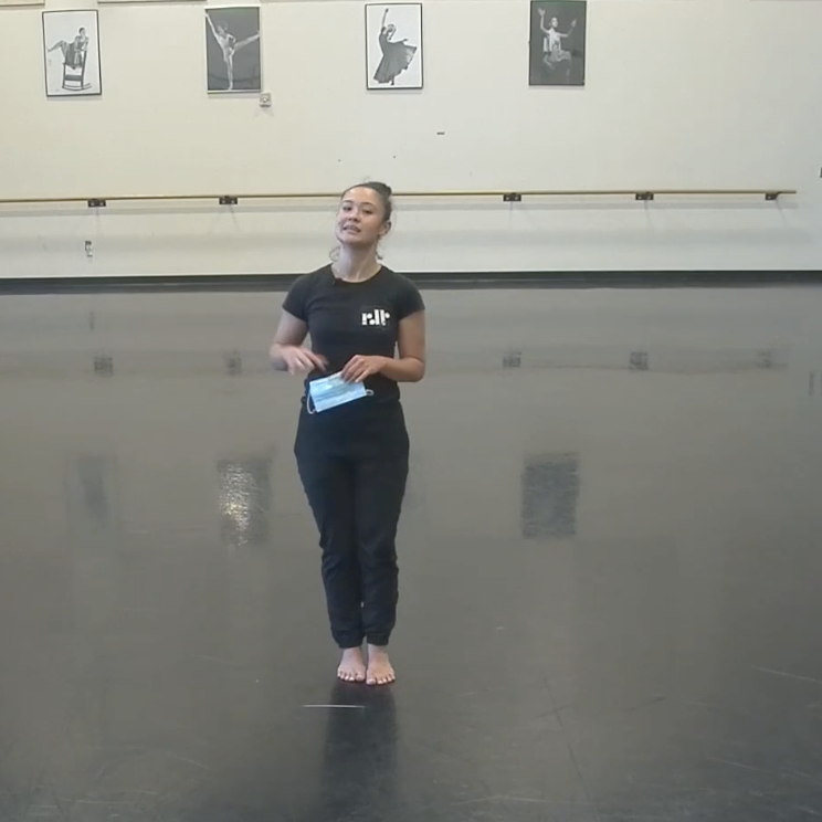 Screenshot of Jessica standing holding a facemask